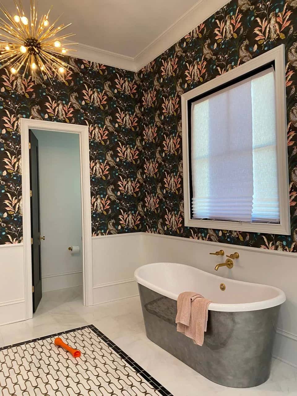 Leopard and foliage wallpaper around a freestanding bath