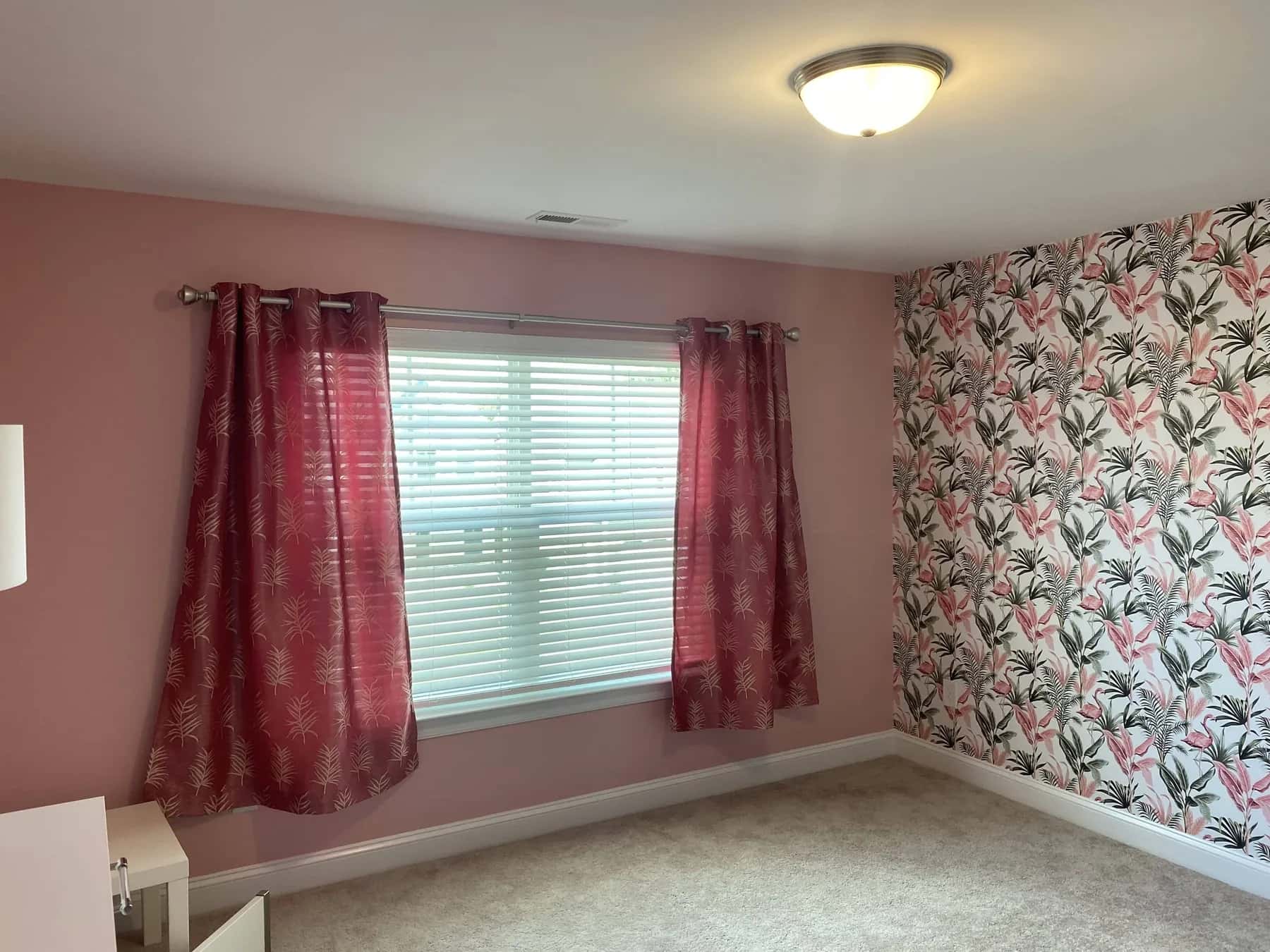 Pink floral wallpaper in a bedroom with white trim