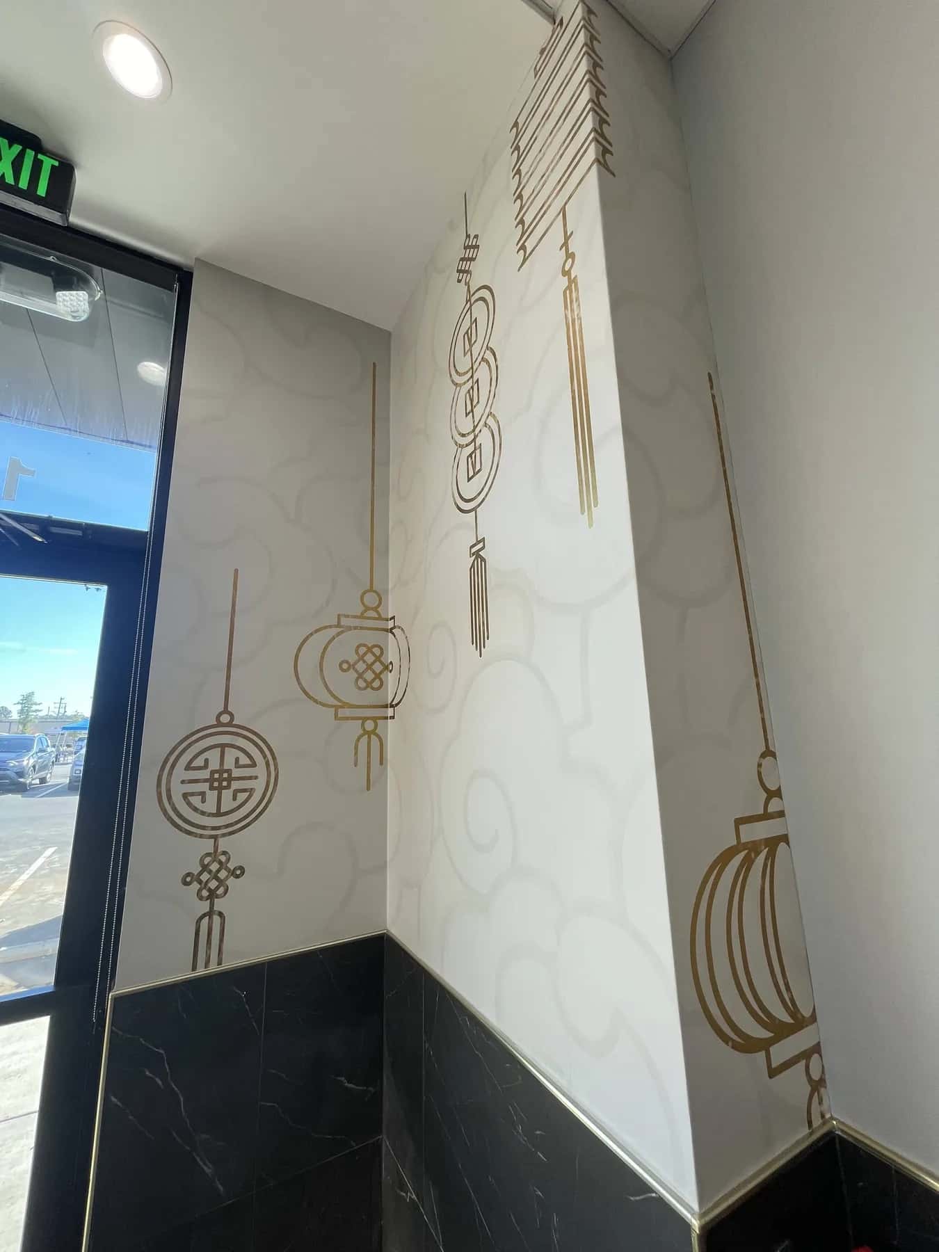 Gold lantern pattern wallcovering in a stairwell