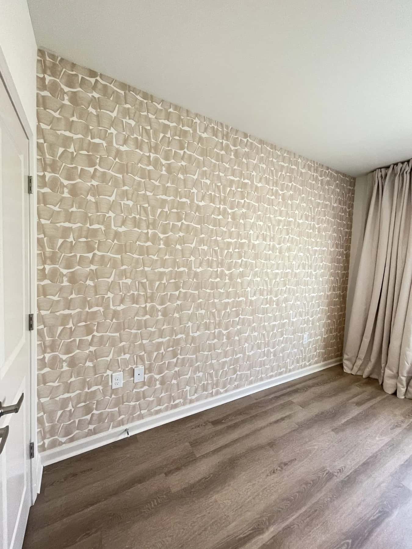Neutral grasscloth wallpaper in a bedroom