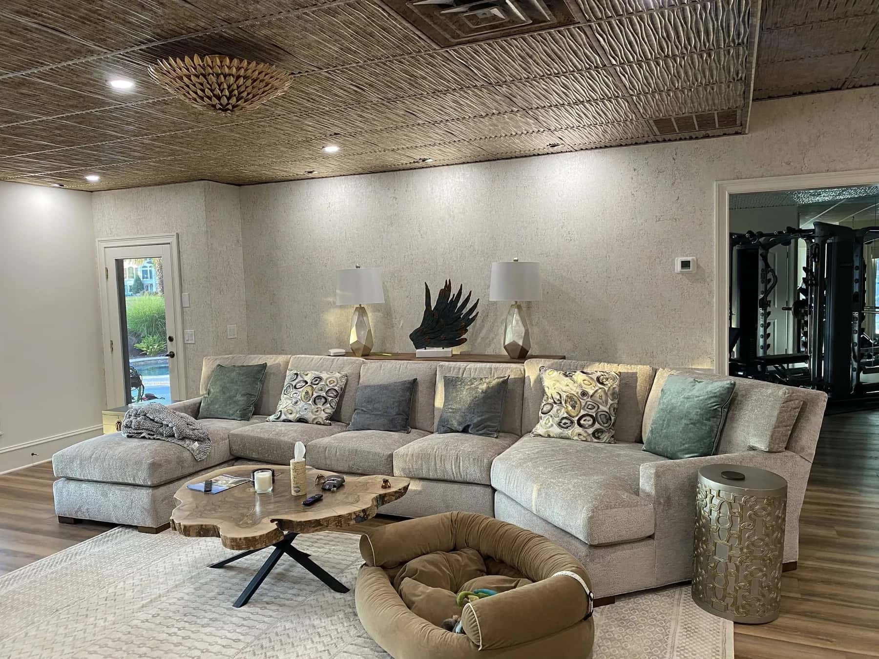 Textured wallcovering and patterned ceiling in a living room