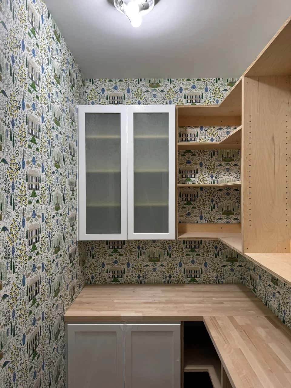 Botanical wallpaper in a fitted pantry