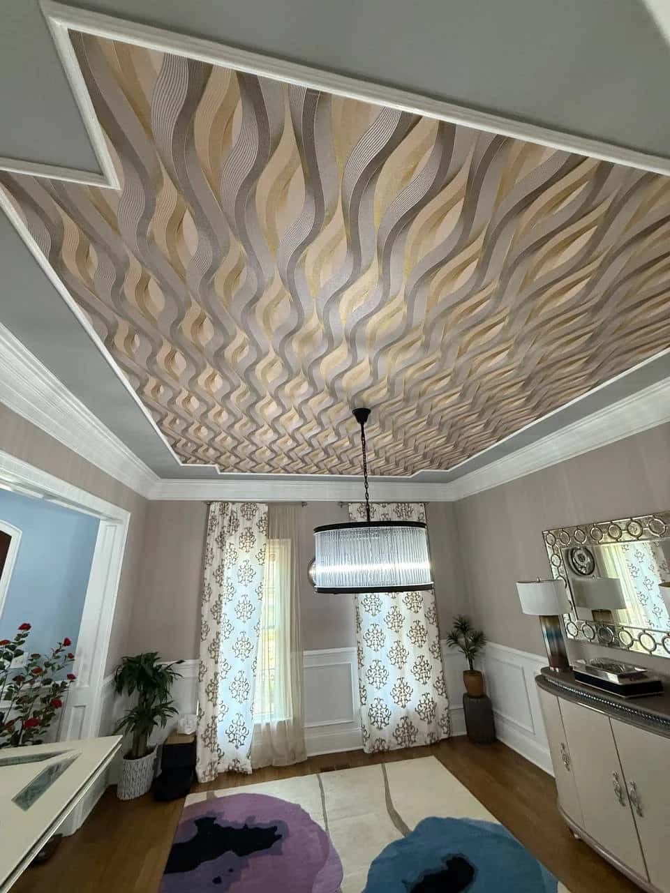 Sculpted wave-pattern wallcovering across a tray ceiling