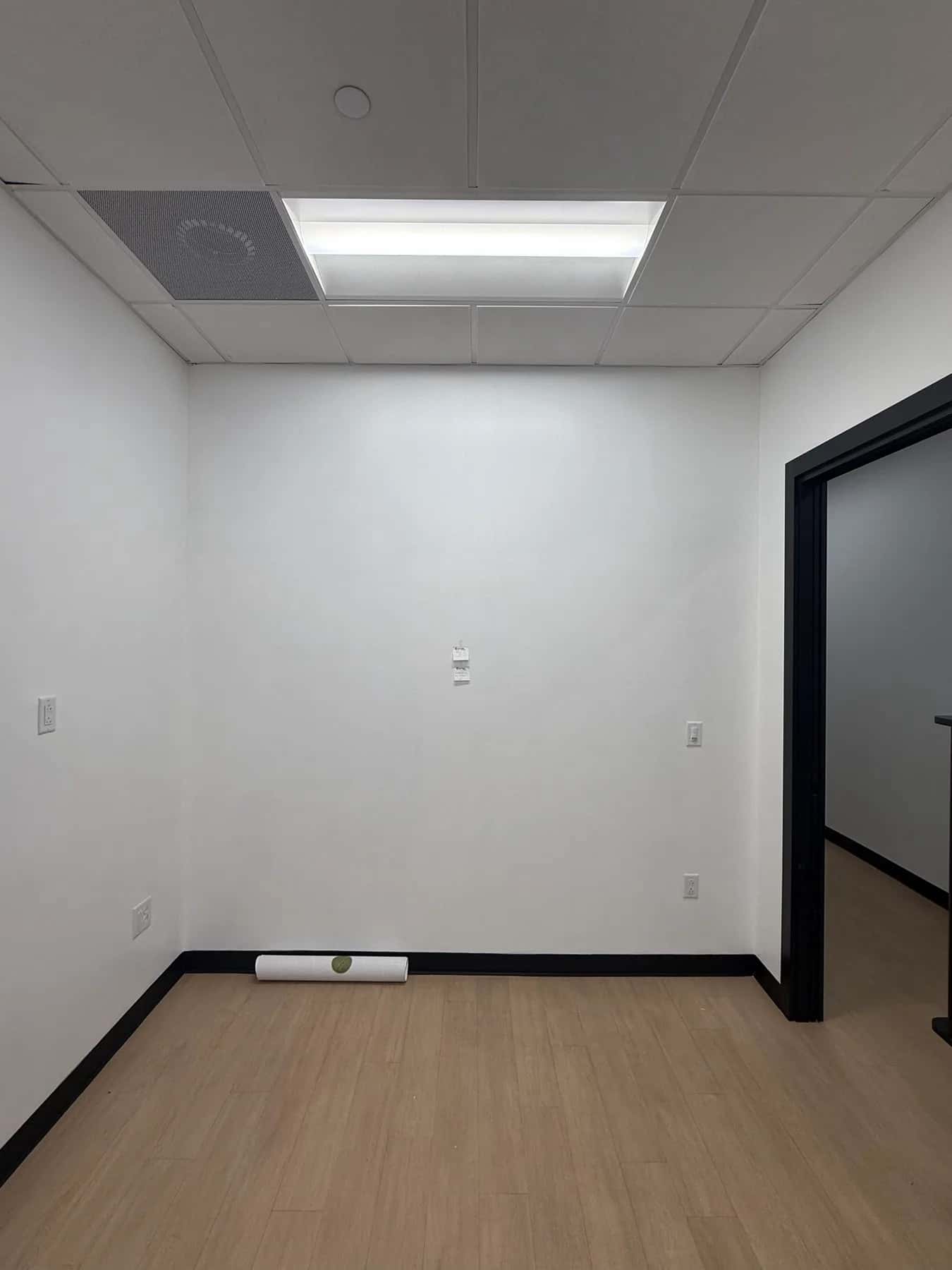 Plain white suite wall at Image Studios in Rock Hill before the wallpaper went up