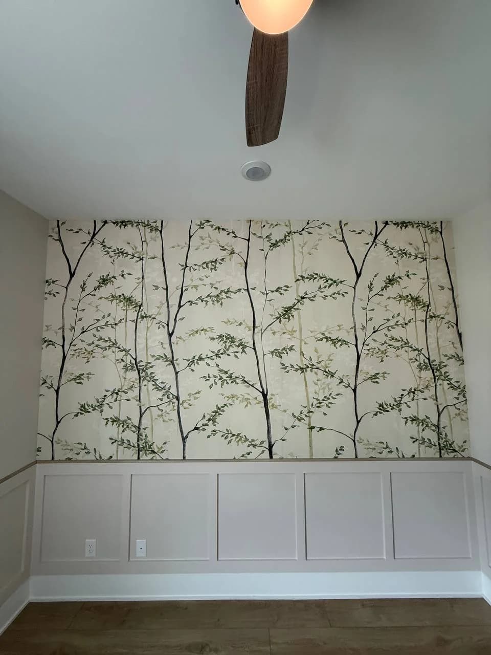 The same bedroom wall after, tree pattern wallpaper