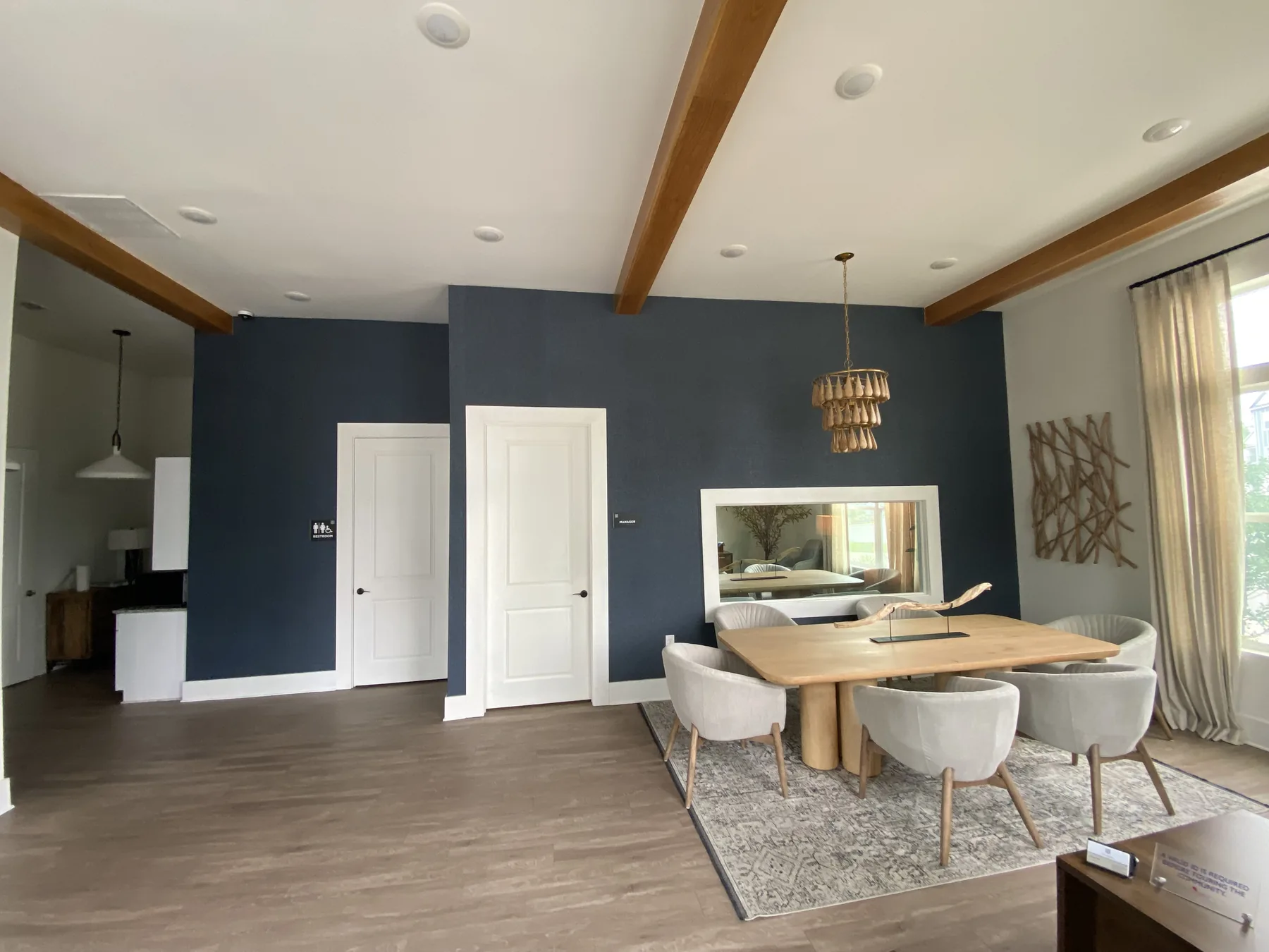 Deep blue accent wall in an open-plan dining room