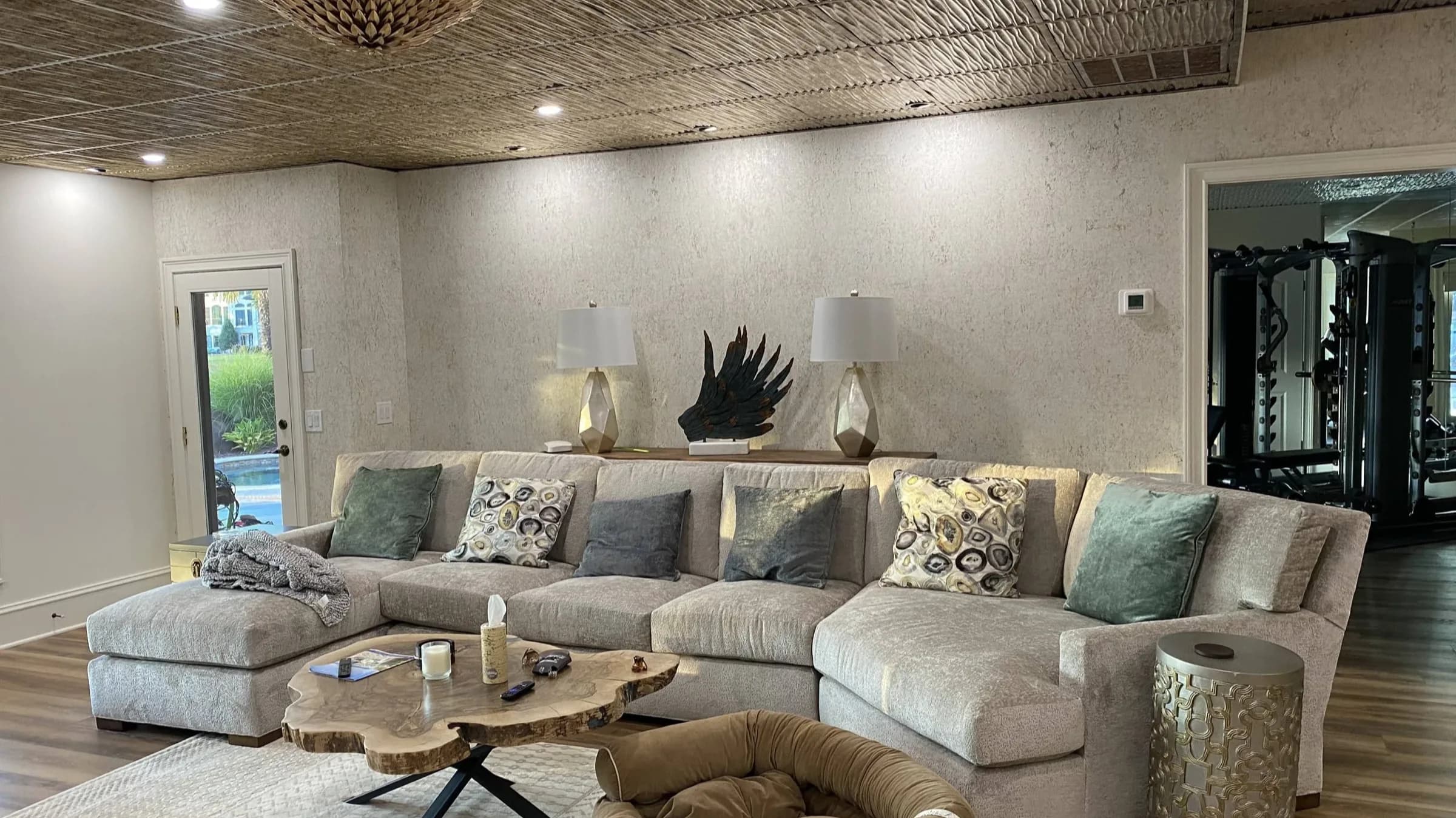 Textured wallcovering and patterned ceiling in a living room