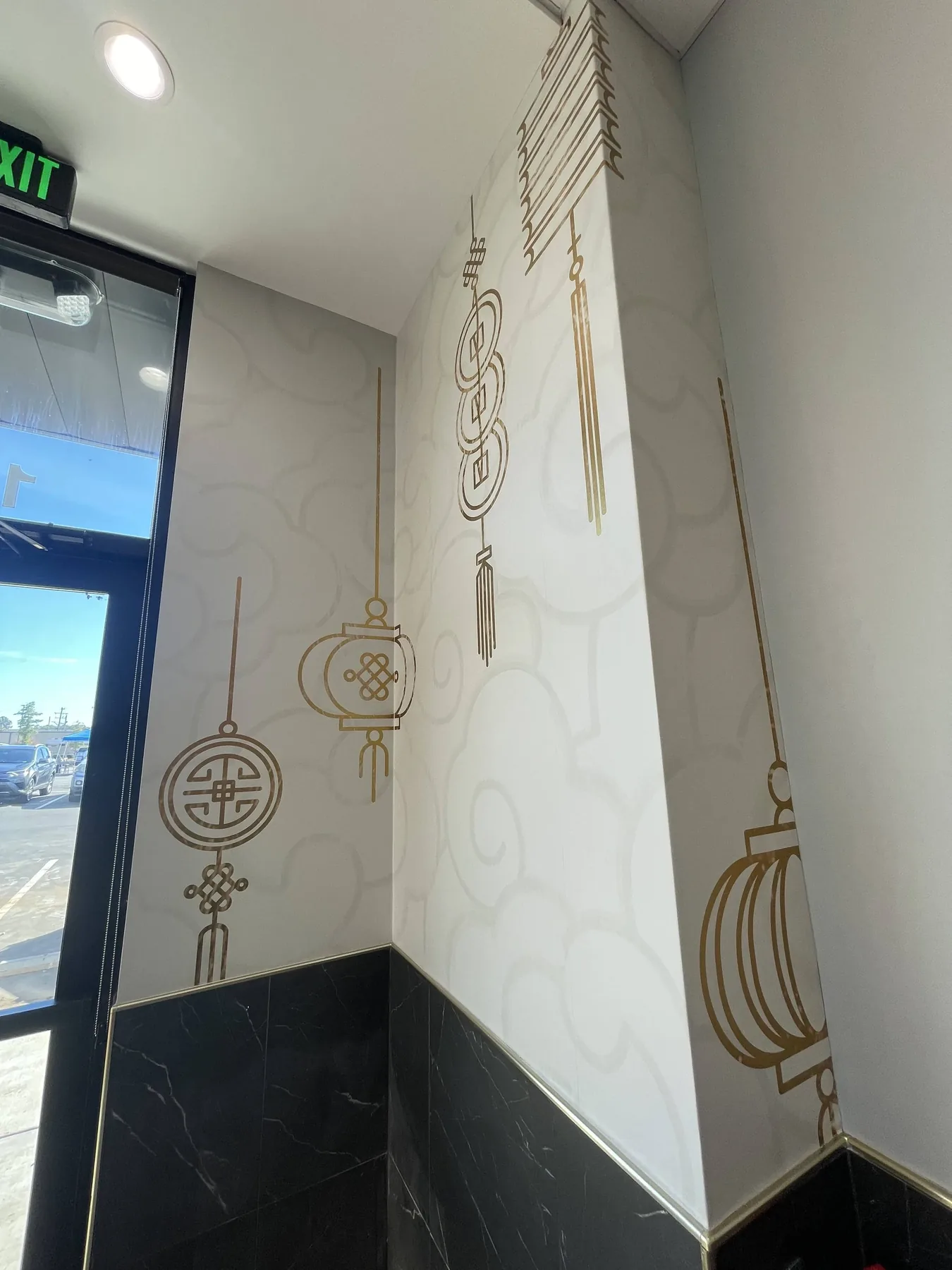 Gold lantern pattern wallcovering in a stairwell